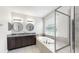 Elegant bathroom with double vanity, soaking tub, frameless glass shower, and modern fixtures at 17740 Bright Wheat Dr, Lithia, FL 33547