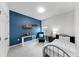 Bedroom with a blue accent wall, study desk, and a cozy chair, illuminated by natural light at 17740 Bright Wheat Dr, Lithia, FL 33547