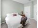 Bedroom featuring neutral tones, a soft white bed, and ample closet space at 17740 Bright Wheat Dr, Lithia, FL 33547