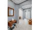 Inviting home entryway features light tile floors, archways, and neutral paint with vintage sewing machine decor at 17740 Bright Wheat Dr, Lithia, FL 33547