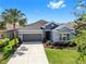 Charming single-story home featuring lush landscaping, a two-car garage, and inviting curb appeal at 17740 Bright Wheat Dr, Lithia, FL 33547