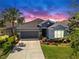 Charming single-story home featuring lush landscaping, a two-car garage, and inviting curb appeal at 17740 Bright Wheat Dr, Lithia, FL 33547