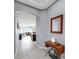 Hallway with arched doorways, neutral paint, tile flooring and a view into the kitchen at 17740 Bright Wheat Dr, Lithia, FL 33547