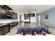 Modern kitchen features an island with seating, stainless appliances, and granite countertops at 17740 Bright Wheat Dr, Lithia, FL 33547