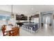 Open-concept kitchen featuring dark cabinets, a large island, and a dining area at 17740 Bright Wheat Dr, Lithia, FL 33547
