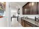 Stylish kitchen features granite counters and flows into an open concept dining and living space at 17740 Bright Wheat Dr, Lithia, FL 33547