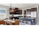 Modern kitchen features an island with seating, stainless appliances, granite counters, and pendant lighting at 17740 Bright Wheat Dr, Lithia, FL 33547