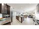 Open kitchen features granite countertops, an island with seating, stainless appliances, and flows into living area at 17740 Bright Wheat Dr, Lithia, FL 33547