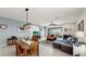 Bright open-concept living room with dining area, comfortable sofas and large glass sliding door to patio at 17740 Bright Wheat Dr, Lithia, FL 33547