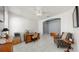 Office with neutral walls, tile flooring, ceiling fan, and view into adjoined living area at 17740 Bright Wheat Dr, Lithia, FL 33547
