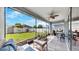 Enjoy outdoor living in this screened patio with a ceiling fan and views of the manicured backyard at 17740 Bright Wheat Dr, Lithia, FL 33547