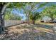 Spacious fenced backyard featuring mature trees offering ample shade, and a hot tub at 1968 Rolling Green Cir, Sarasota, FL 34240