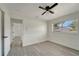 Bedroom featuring a ceiling fan, light gray floors and a large window at 1968 Rolling Green Cir, Sarasota, FL 34240