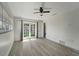 Bedroom with new flooring, ceiling fan, and French doors, connecting indoor and outdoor spaces at 1968 Rolling Green Cir, Sarasota, FL 34240
