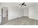 Bedroom with a ceiling fan, gray floors and lots of natural light at 1968 Rolling Green Cir, Sarasota, FL 34240