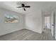 Bedroom with a ceiling fan, large window, and gray flooring at 1968 Rolling Green Cir, Sarasota, FL 34240