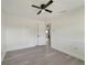 Bright bedroom featuring a ceiling fan, light gray vinyl floors and a white door at 1968 Rolling Green Cir, Sarasota, FL 34240