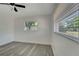 Bedroom with a gray vinyl floor, a window and a ceiling fan at 1968 Rolling Green Cir, Sarasota, FL 34240
