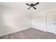 A clean, bright bedroom with modern gray vinyl plank flooring and a ceiling fan for enhanced comfort at 1968 Rolling Green Cir, Sarasota, FL 34240