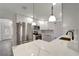 Bright, updated kitchen with stainless steel appliances, modern lighting, and stylish countertops at 1968 Rolling Green Cir, Sarasota, FL 34240