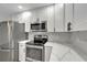 Modern kitchen featuring sleek stainless steel appliances and light countertops at 1968 Rolling Green Cir, Sarasota, FL 34240