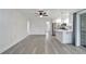 Spacious living area with sleek, light-colored flooring and an open layout leading to the kitchen at 1968 Rolling Green Cir, Sarasota, FL 34240
