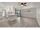 Living space with new flooring, white walls, and a remodeled kitchen with white cabinets and countertops at 1968 Rolling Green Cir, Sarasota, FL 34240