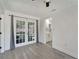 Open-concept living room with new vinyl plank flooring, recessed lighting, and French doors leading to the Kitchen at 1968 Rolling Green Cir, Sarasota, FL 34240