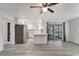 Open living space with new flooring, updated kitchen with stainless steel appliances, and sliding glass doors at 1968 Rolling Green Cir, Sarasota, FL 34240