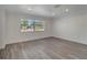 Spacious living room featuring new vinyl plank flooring, recessed lighting and a large window at 1968 Rolling Green Cir, Sarasota, FL 34240
