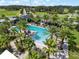 Aerial view of a luxurious pool area surrounded by palm trees and lush landscaping at 2106 Alimara Ct, Odessa, FL 33556