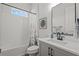 Cozy bathroom with shower/tub combo, white subway tiles, gray vanity, and framed mirror at 2106 Alimara Ct, Odessa, FL 33556