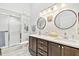Modern bathroom with double sinks, elegant vanity, and glass-enclosed shower at 2291 Americus W Blvd # 41, Clearwater, FL 33763