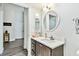 Cozy bathroom with a modern sink, vanity, and framed mirror with seamless access to a hall at 2291 Americus W Blvd # 41, Clearwater, FL 33763