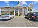 Exterior of a lovely two-story condominium complex with ample parking for residents and guests on a bright, sunny day at 2291 Americus W Blvd # 41, Clearwater, FL 33763