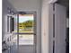 Bright entryway featuring a decorative front door with lake views and access to other rooms at 2291 Americus W Blvd # 41, Clearwater, FL 33763