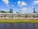 Well-maintained condo complex exterior with lush landscaping, ample parking, and waterfront views at 2291 Americus W Blvd # 41, Clearwater, FL 33763