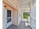Condo hallway entrance featuring an exit and view of lush green trees, inviting residents to a peaceful outdoor setting at 2291 Americus W Blvd # 41, Clearwater, FL 33763