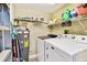 Functional laundry room with washer, dryer, water heater, and shelving for storage and organization at 2291 Americus W Blvd # 41, Clearwater, FL 33763