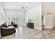 Bright living room featuring soaring ceilings, bay windows, and sleek, updated floors at 2291 Americus W Blvd # 41, Clearwater, FL 33763