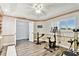 Well-lit home office featuring hardwood floors, neutral walls, built-in shelving, and exercise equipment at 2291 Americus W Blvd # 41, Clearwater, FL 33763