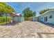 Spacious backyard featuring a large brick paver patio, gazebo, and well-maintained landscaping at 3045 Stratford Dr, Largo, FL 33771
