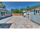 Spacious backyard featuring a large brick paver patio, gazebo, sheds, and well-maintained landscaping at 3045 Stratford Dr, Largo, FL 33771