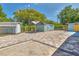 Spacious backyard featuring a large brick paver patio, gazebo, sheds, and well-maintained landscaping at 3045 Stratford Dr, Largo, FL 33771