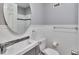 Updated bathroom with beadboard wainscoting, modern sink, and stylish fixtures at 3045 Stratford Dr, Largo, FL 33771