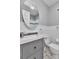 Bathroom featuring updated wainscoting, fixtures, oval mirror, and tiled accent at 3045 Stratford Dr, Largo, FL 33771