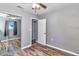 Bedroom features wood-look flooring, a ceiling fan and closet with mirrored doors at 3045 Stratford Dr, Largo, FL 33771