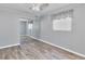 Bedroom with wide closet, ceiling fan, wood-look floors, and natural lighting at 3045 Stratford Dr, Largo, FL 33771