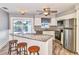 Modern kitchen with stainless steel appliances, granite countertops, an island with seating, and tile floors at 3045 Stratford Dr, Largo, FL 33771