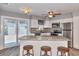Modern kitchen with stainless steel appliances, granite countertops, an island with seating, and tile floors at 3045 Stratford Dr, Largo, FL 33771